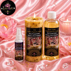 Kit Luxo e Prosperidade sobre tecido rosa, com vela acesa, flores de lótus e cristais